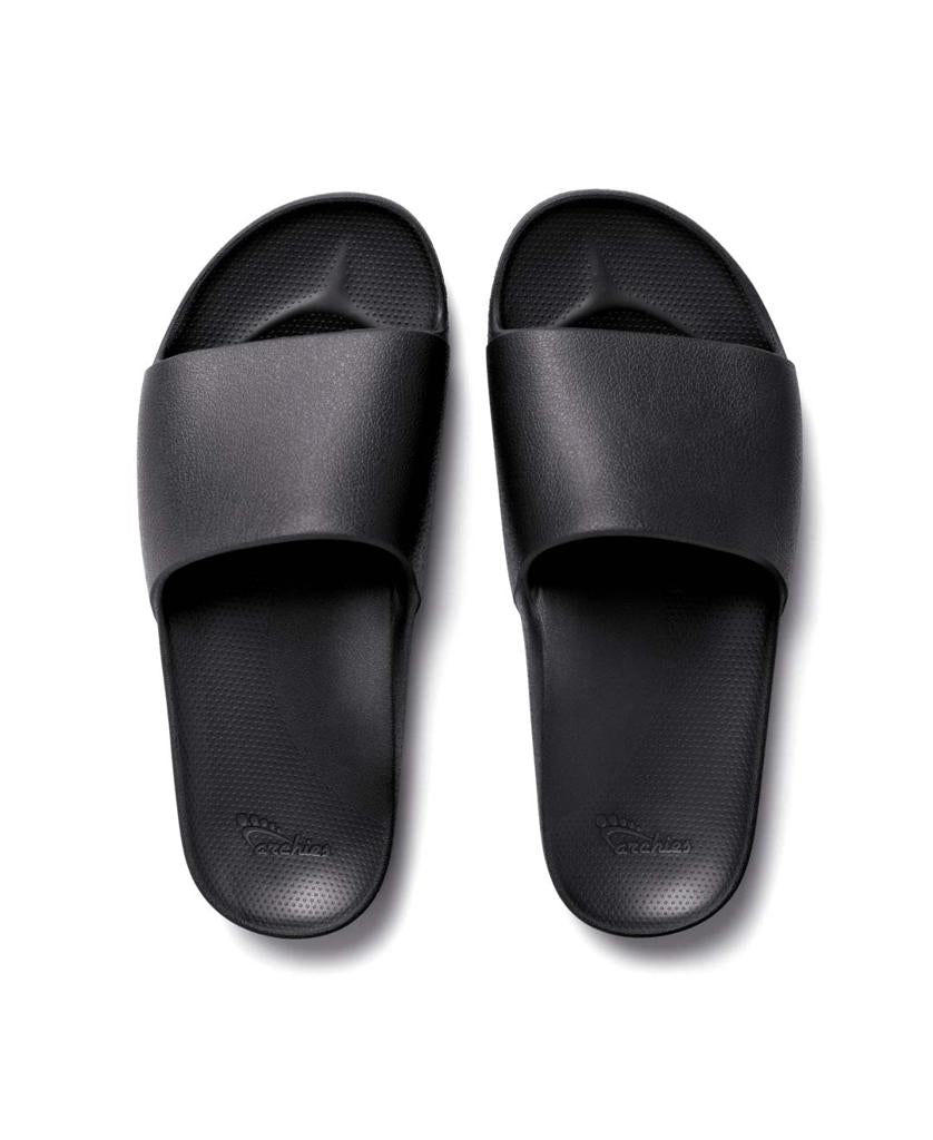 The Archies Archie Slide | Black features a wide strap and a textured closed cell foam footbed, shown on a white background.
