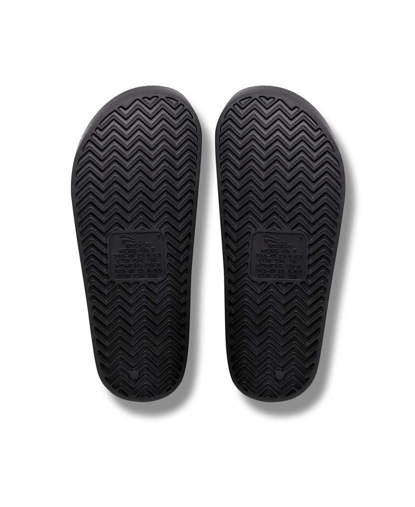 The Archies Archie Slide | Black features a zigzag tread sole with a rectangular textured label area, crafted from closed cell foam for extra comfort.