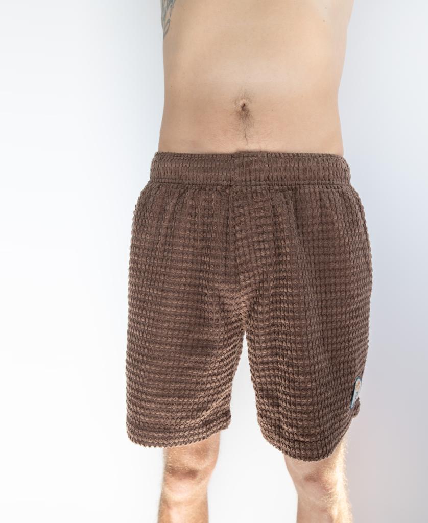 A person models the Golden Breed El Shorto Walkshort in Wash Brown, featuring an elastic waist and cord texture, against a plain white background; only the shorts and lower body are visible.