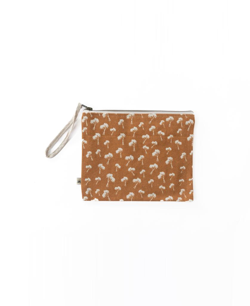 The Bomba WET BIKINI Palm Repeat is a rectangular brown pouch with a wrist strap, white palm pattern, zipper closure, and waterproof interior—perfect as a wet bikini bag—shown on a plain white background.