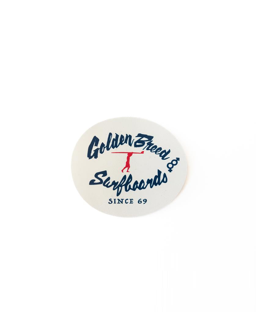 Cream-colored round sticker by Golden Breed featuring a blue Golden Breed Surfboards Since 69 design and a red silhouette of a surfer with board. Proudly Australian made. Product: GB Dude Sticker | Cream.