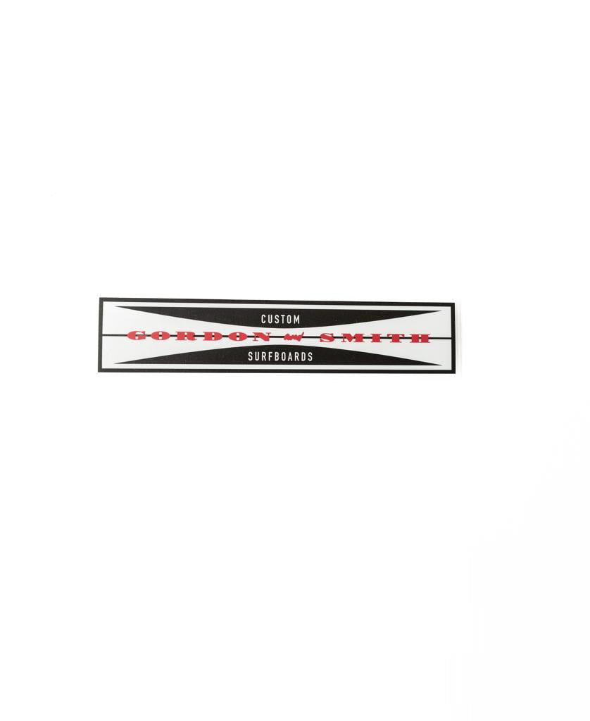 The G&S Eric Sticker 165mm by Gordon & Smith features CUSTOM GORDON & SMITH SURFBOARDS text in red and black on white, bordered by black geometric shapes.