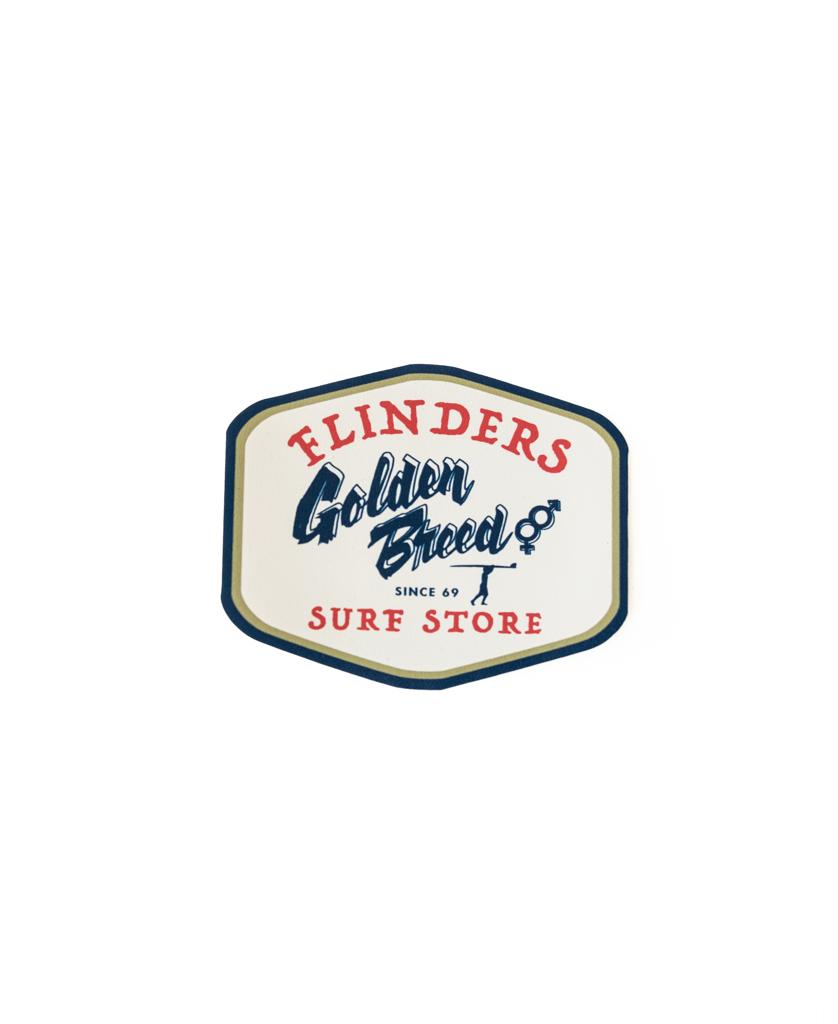 The Flinders Al Sticker | Cream by Golden Breed features blue and red text on a white, shield-shaped design. Made in Australia, this high-quality sticker is perfect for collectors.
