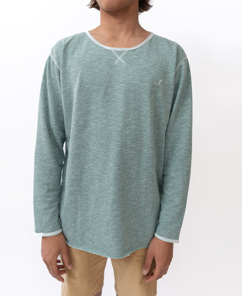 A person wearing the Golden Breed Classic Rag Top in Surf Green Marle and tan pants stands against a plain white background.