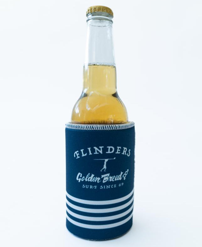 A Flinders Stubby Beach Boy | Navy by Golden Breed holds a glass beer bottle, featuring blue and white stripes, on a plain white background.