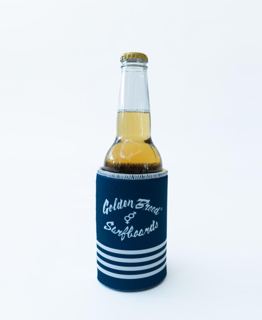The Flinders Stubby Beach Boy | Navy by Golden Breed features a clear glass bottle with a golden cap in a navy neoprene holder, displayed against a plain white background.