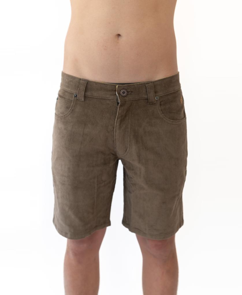 A person models the Golden Breed Floyd Cord Walkshort in Wash Brown, featuring a structured waist, standing against a white background and shown from the waist to above the knees.