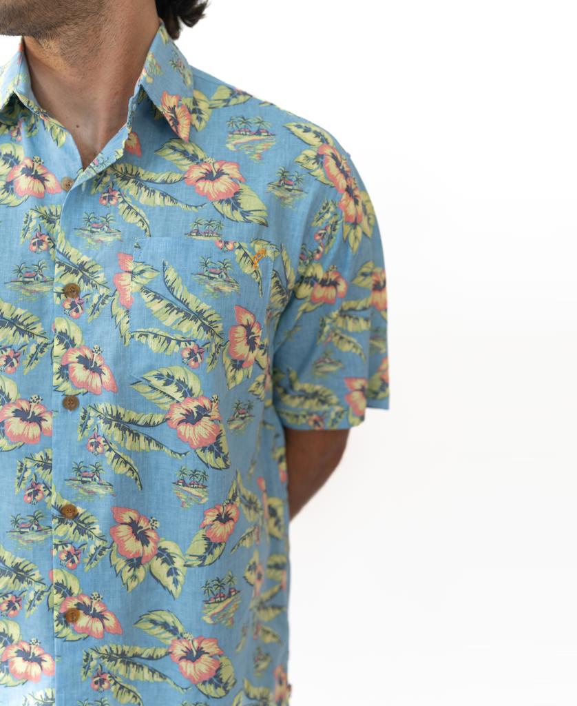 A person wears the Golden Breed Howe Shirt in Azure Blueβan oversized, short-sleeve Hawaiian shirt with a floral patternβstanding against a plain white background.