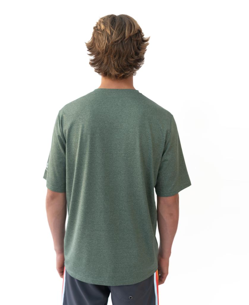 A person with light brown hair, facing away from the camera against a white background, wears the Golden Breed Nemo S/S Rash Shirt in Green Marle and dark shorts.