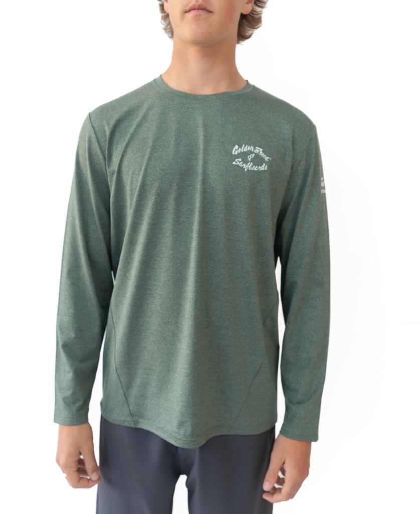 A person wears the Golden Breed Pebbles L/S Rash Shirt in green marle, featuring 50+ UPF sun protection and white chest text, standing before a plain white background.
