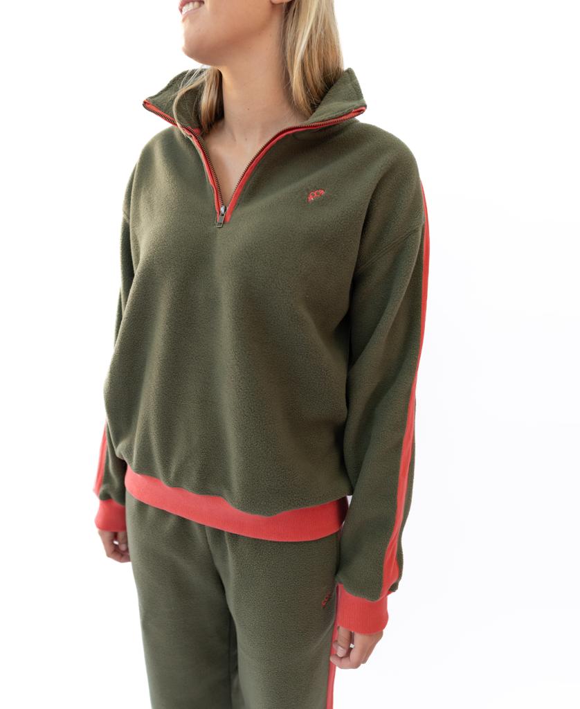 Woman wearing the Golden Breed Peggy 1/2 Zip Retro fleece in dark khaki with red trim, standing against a white background and facing slightly to the side.