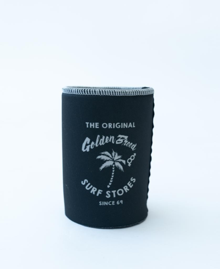The Golden Breed Ray Stubby Holder in Wash Black features The Original Golden Breed Surf Stores Since 69 and a white palm tree graphic on the front.