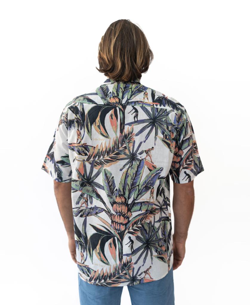 A man with shoulder-length hair, seen from behind, wears a Golden Breed Surfer Palm Shirt in Off White (cotton/linen blend) with light blue pants against a white background.