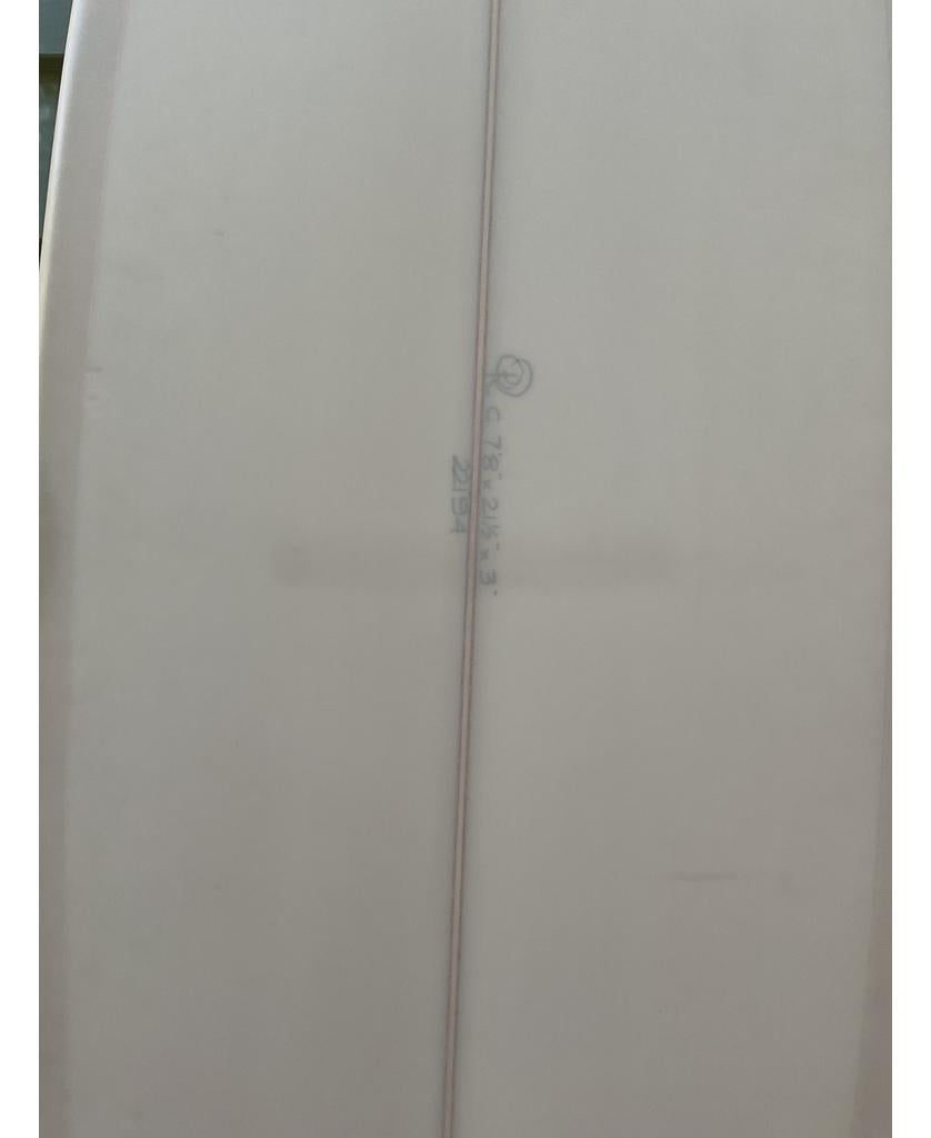 Close-up of the Gordon & Smith G&S 78 Cool Tool Mid Twin | Cream surfboard, featuring a visible stringer and handwritten markings, designed for relaxed surfing and superior wave-catching ability.