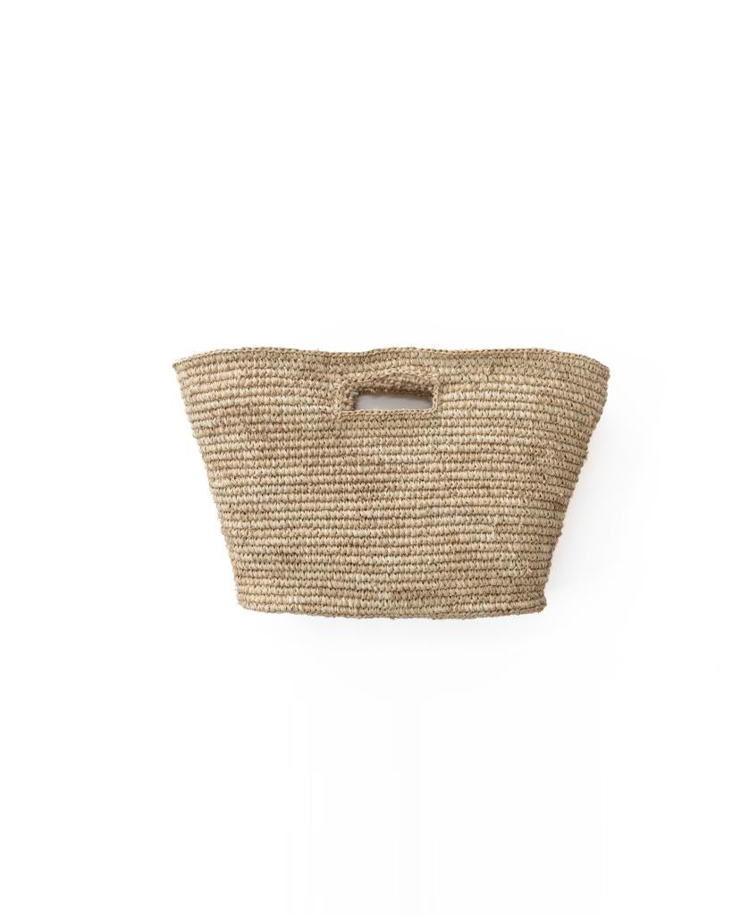 The Lazy Beach Raffia Basket | Natural, featuring rectangular cutout handles, is shown against a plain white background—perfect for carrying your beach essentials.