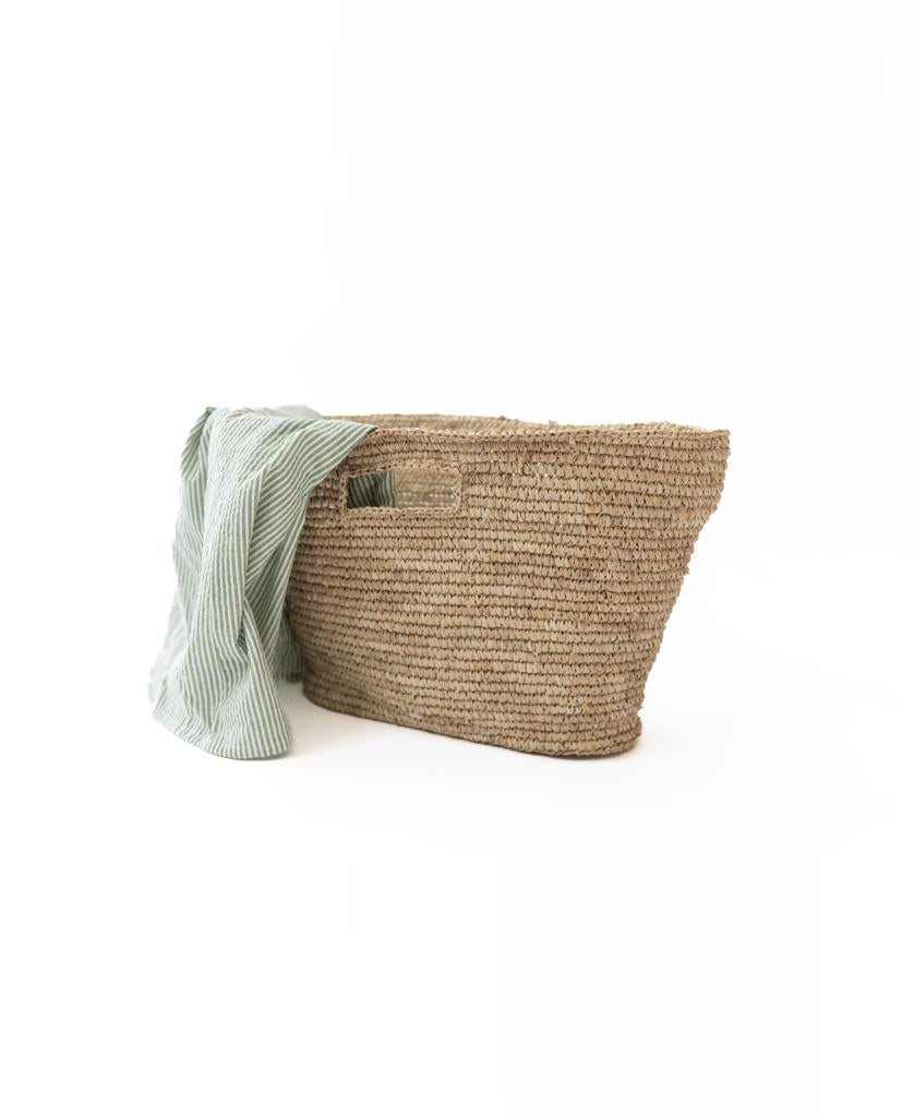 The Lazy Beach Raffia Basket | Natural features rectangular handles and a light green striped cloth accent, set against a white background—ideal for carrying your beach essentials in style.