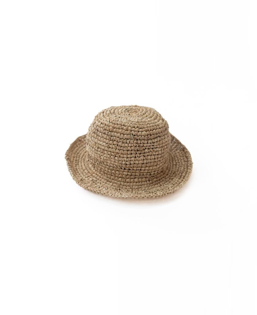 The Lazy Beach Raffia Bucket Hat | Natural features a handmade design with a rounded crown and short, upturned brim—ideal for summer. Shown against a plain white background.