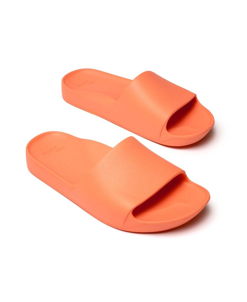 A pair of Archies Archie Slide | Peach arch support slides with a wide strap and textured footbed, made from closed cell foam, shown on a white background.
