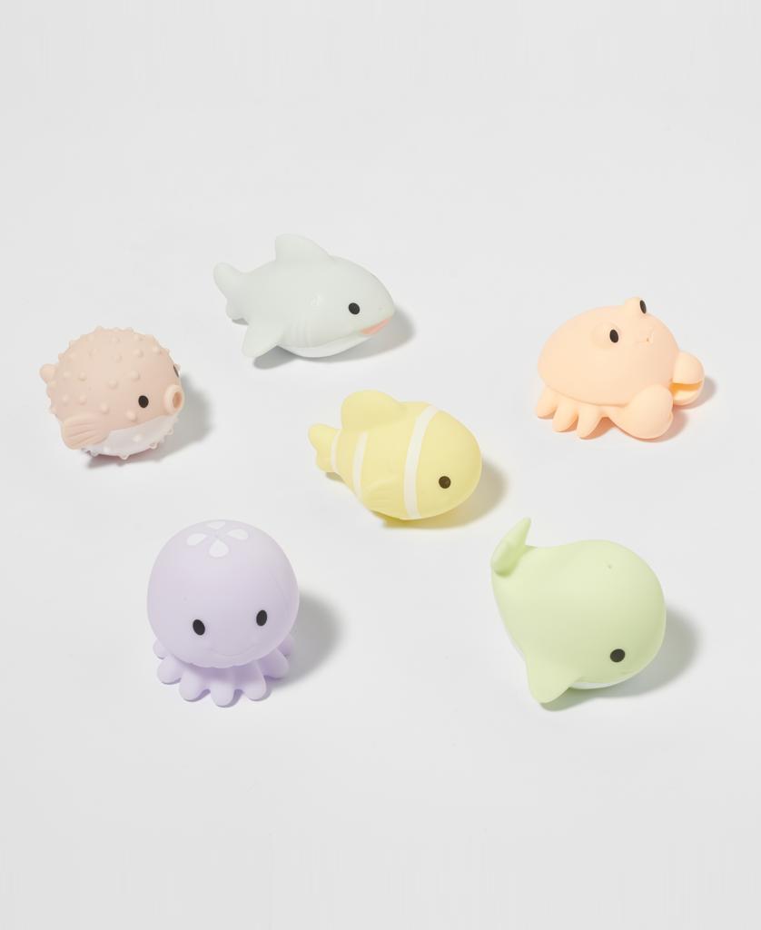 Six pastel Sea Animal Splash Toys by Sunny Life, from the Ocean Friends set, featuring a pufferfish, shark, crab, clownfish, octopus, and whale, arranged on a plain white background.