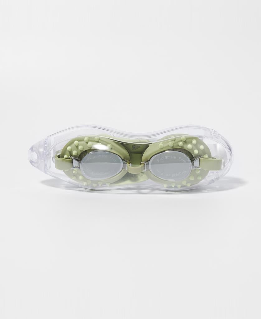 A pair of Sunny Life Kids Swim Goggles Cookie the Croc in Khaki, featuring textured details and anti-fog lenses, shown in a transparent carrying case on a plain white background.