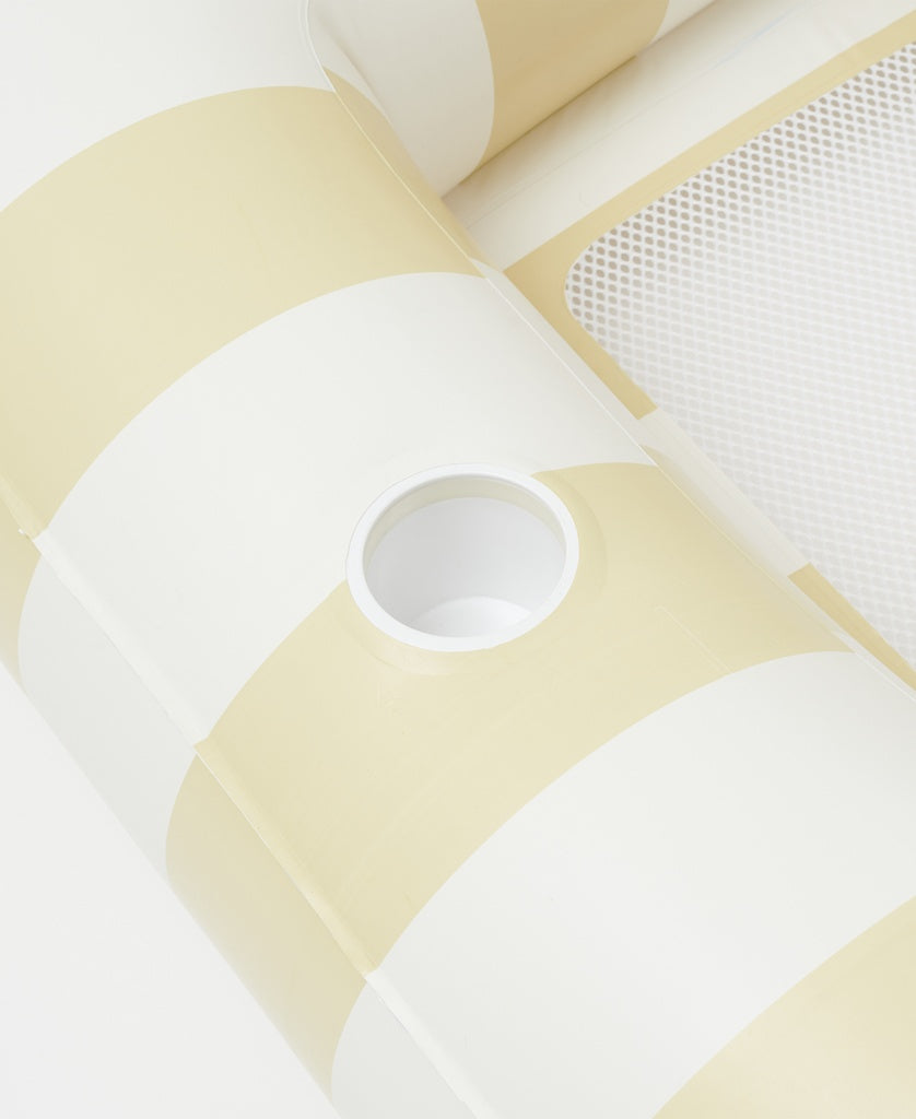 Close-up of the Sunny Life Luxe Twin Hammock Float Mango Bay | Soft Mustard, featuring a golden mustard and cream maxi stripe, mesh panel, built-in cup holder—an oversized, stylish float ideal for relaxing.