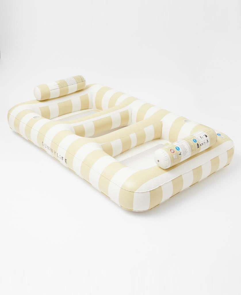 The Sunny Life Luxe Twin Hammock Float Mango Bay in Soft Mustard features a golden mustard and cream maxi stripe print, built-in headrests, and cup holders. Displayed on a plain white background.
