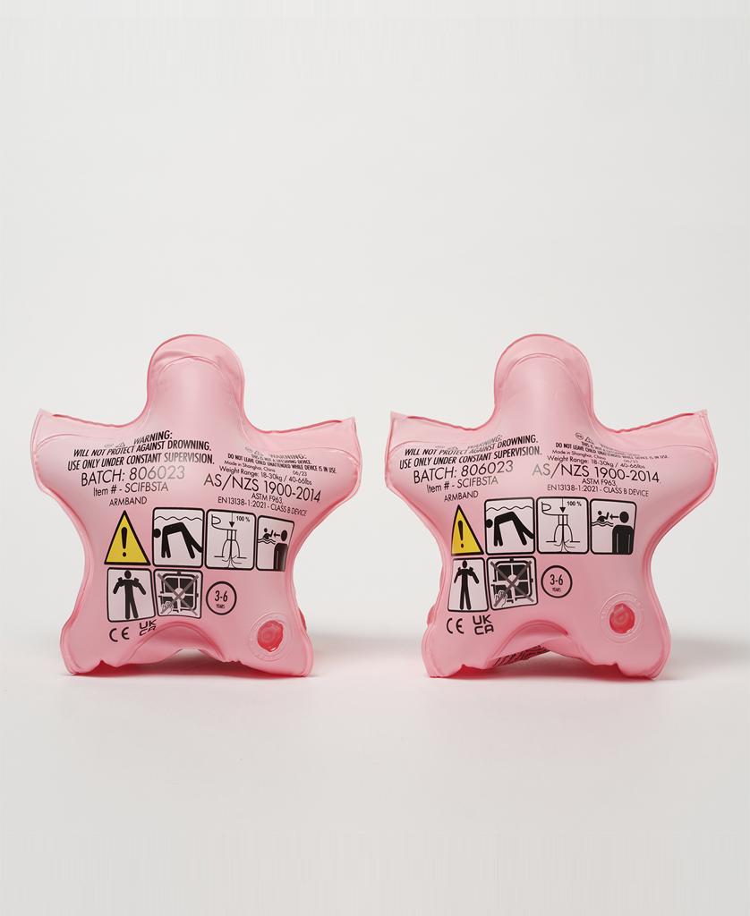 Two pink, star-shaped Melody the Mermaid Float Bands | Strawberry by Sunny Life are shown side by side with safety symbols and instructions, making a fun and safe swimming accessory against a plain white background.