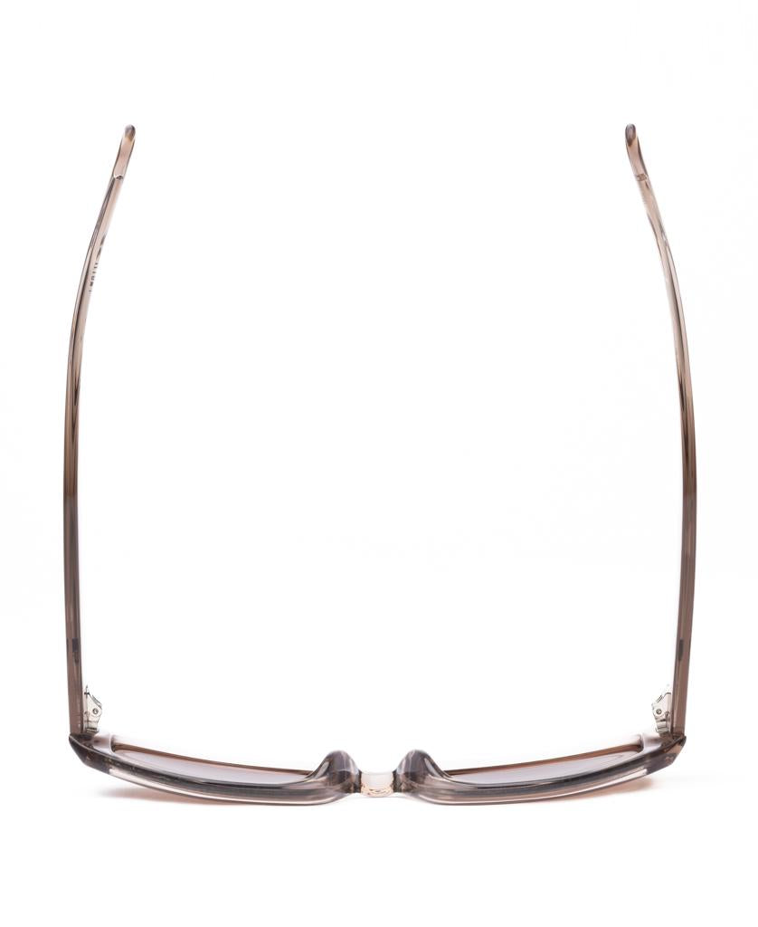 The Sito Diamond | Chintz / Coffee eyeglasses are shown from above, highlighting their transparent brown plant-based acetate frames and open arms against a white background.