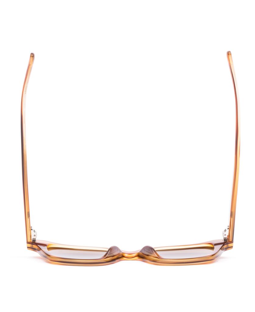 The Sito Ryker eyeglasses in Tangelo/Brown Polar are displayed upright with arms open, featuring rectangular, amber-colored plant-based acetate frames against a white background.