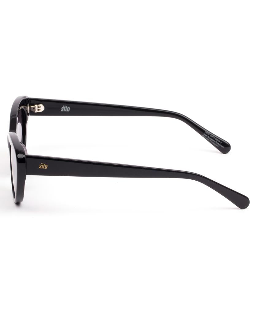 Side view of Sito Siena eyeglass frames in black/smokey grey, featuring a matte plant-based acetate finish, straight arms, and subtle gold branding near the hinges.