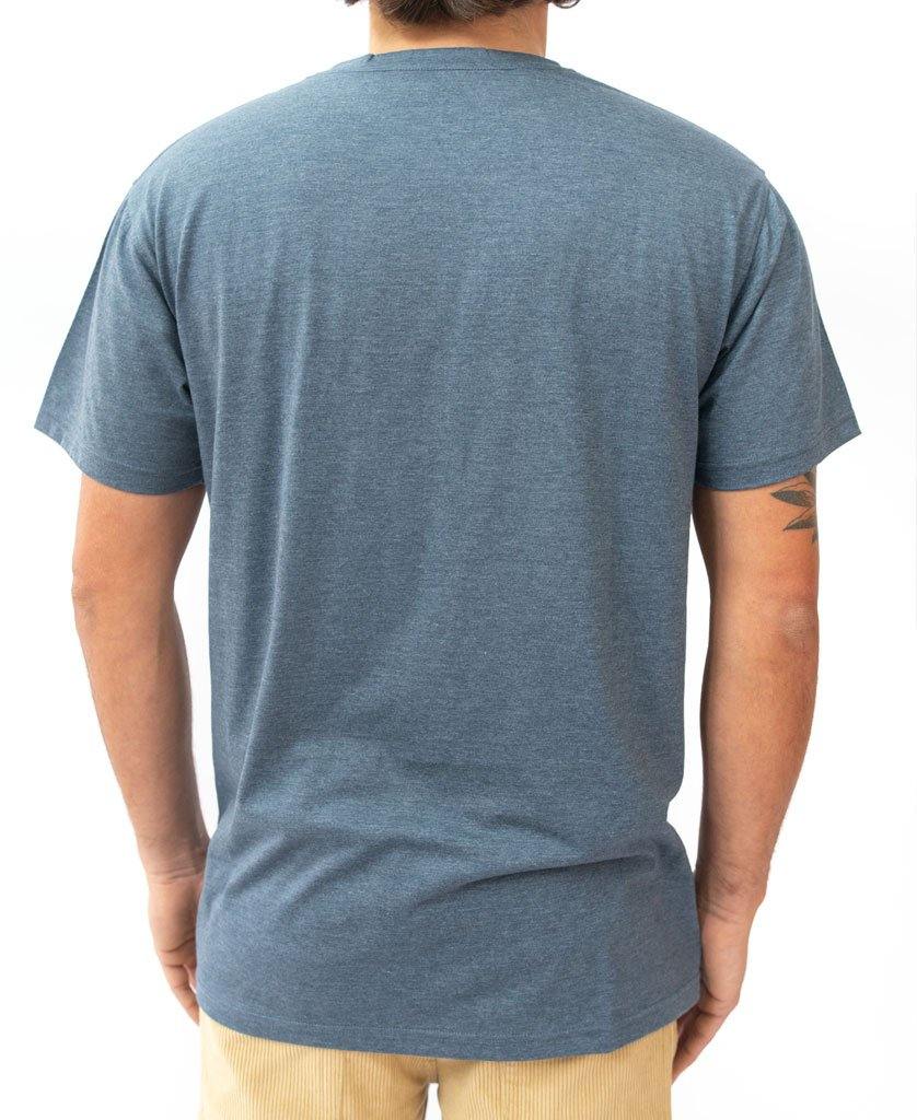 A person is seen from the back in Golden Breeds Long island Tee | Navy Marle against a white background, paired with beige pants for a relaxed California surf vibe.