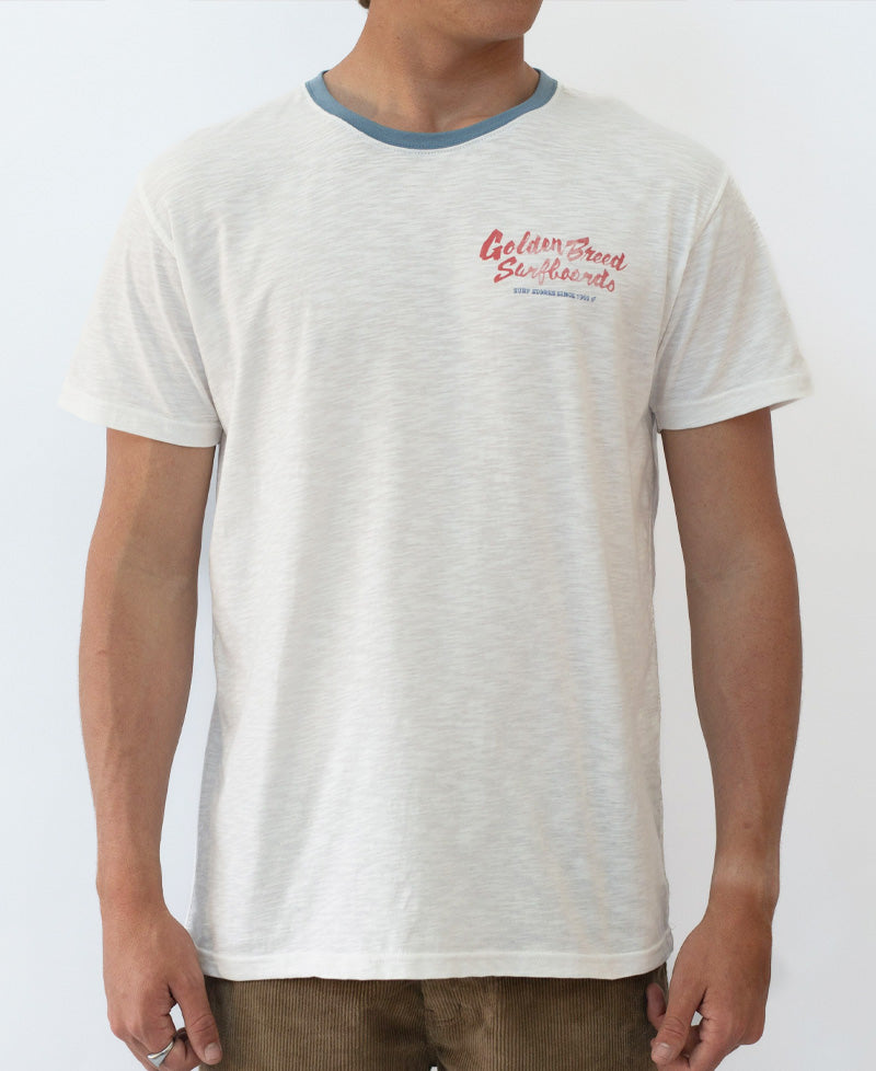 Off-white Surf Loco Tee with blue ringer collar and red Golden Breed Surfboards chest logo.