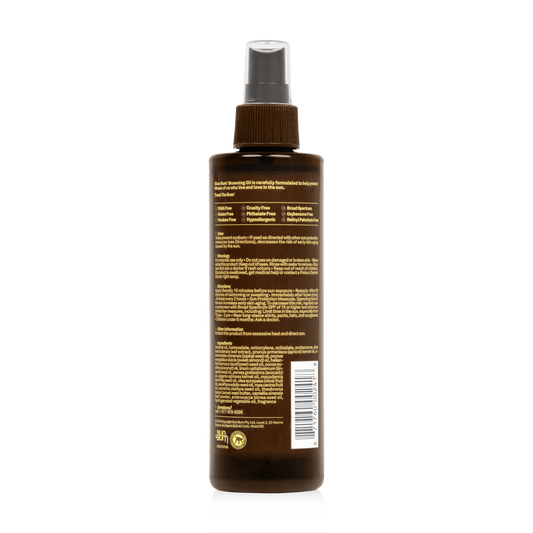 A brown Sun Bum SPF15 Browning Oil spray bottle (250ml) with a gray cap features a back label with product details and directions, offering tanning oil and sun protection.