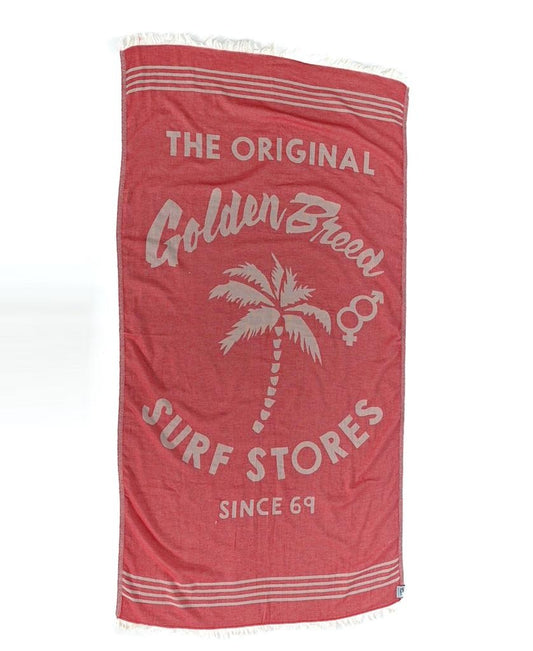 The GB Otto Towel in red by Golden Breed is a soft, fast-drying Turkish cotton beach towel featuring white “The Original Golden Breed Surf Stores Since 69” text and a palm tree illustration—perfect for all your beach adventures.
