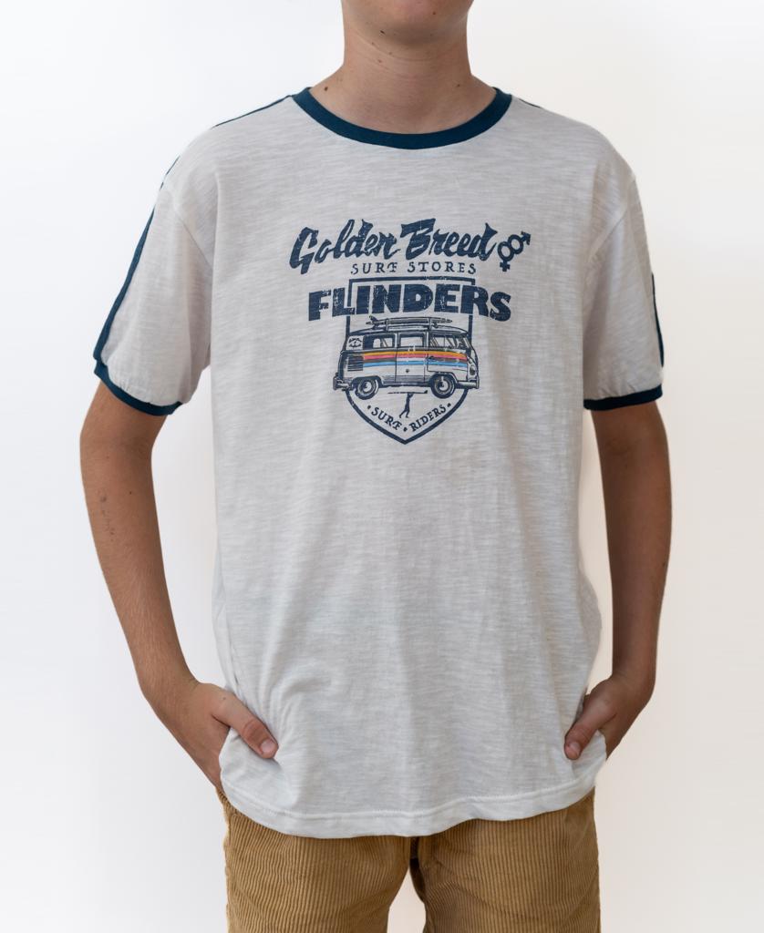 A child wears the Golden Breed Flinders Rider Kids Tee in off white, featuring a surf-inspired graphic, paired with brown corduroy pants—hands in pockets. Designed in Australia for classic surf style.
