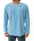 A person in the Golden Breed Classic Rag Top | Sky Marle, a light blue long-sleeve shirt with white stitching, captures a classic surf look against a plain white background.