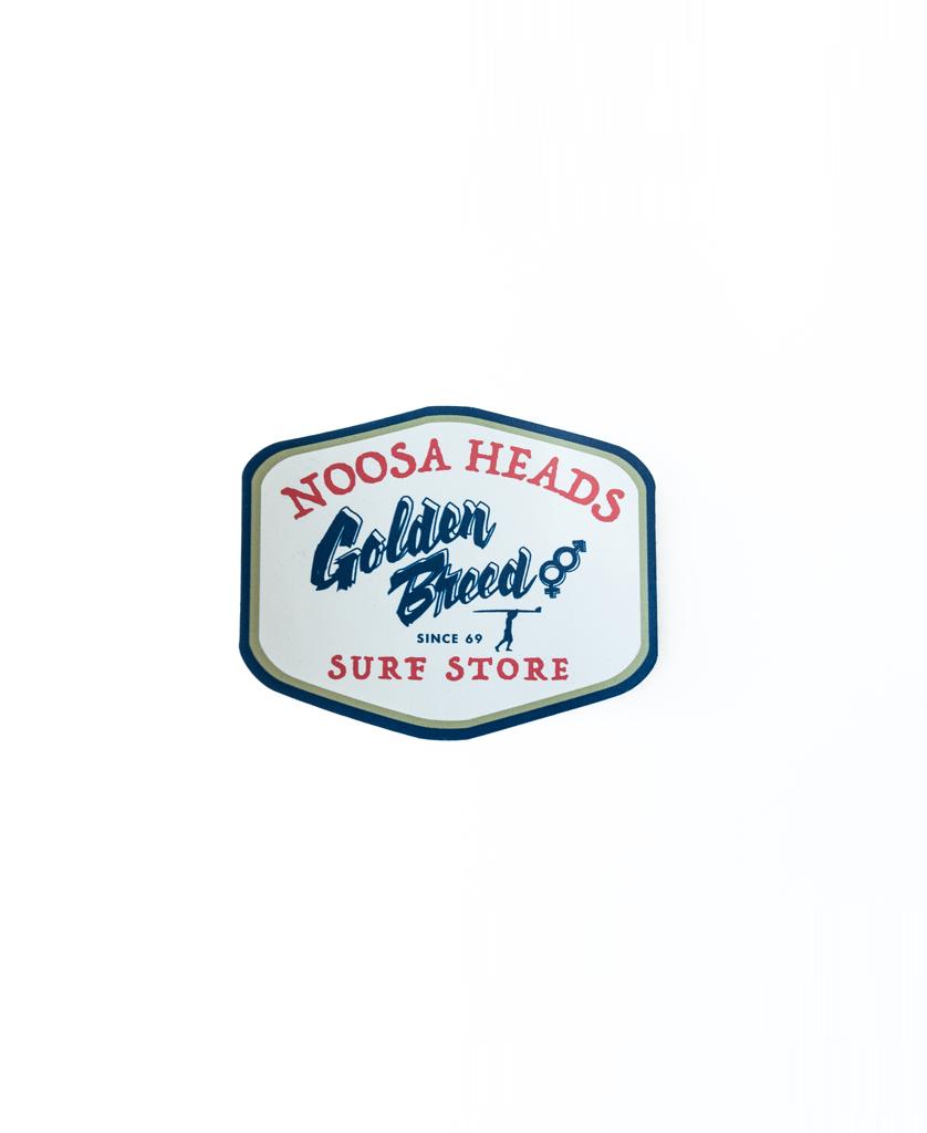 A badge-shaped GB Noosa Al Sticker by Golden Breed features Noosa Heads Golden Breed Since 69 Surf Store in red and blue on a high-quality cream background.
