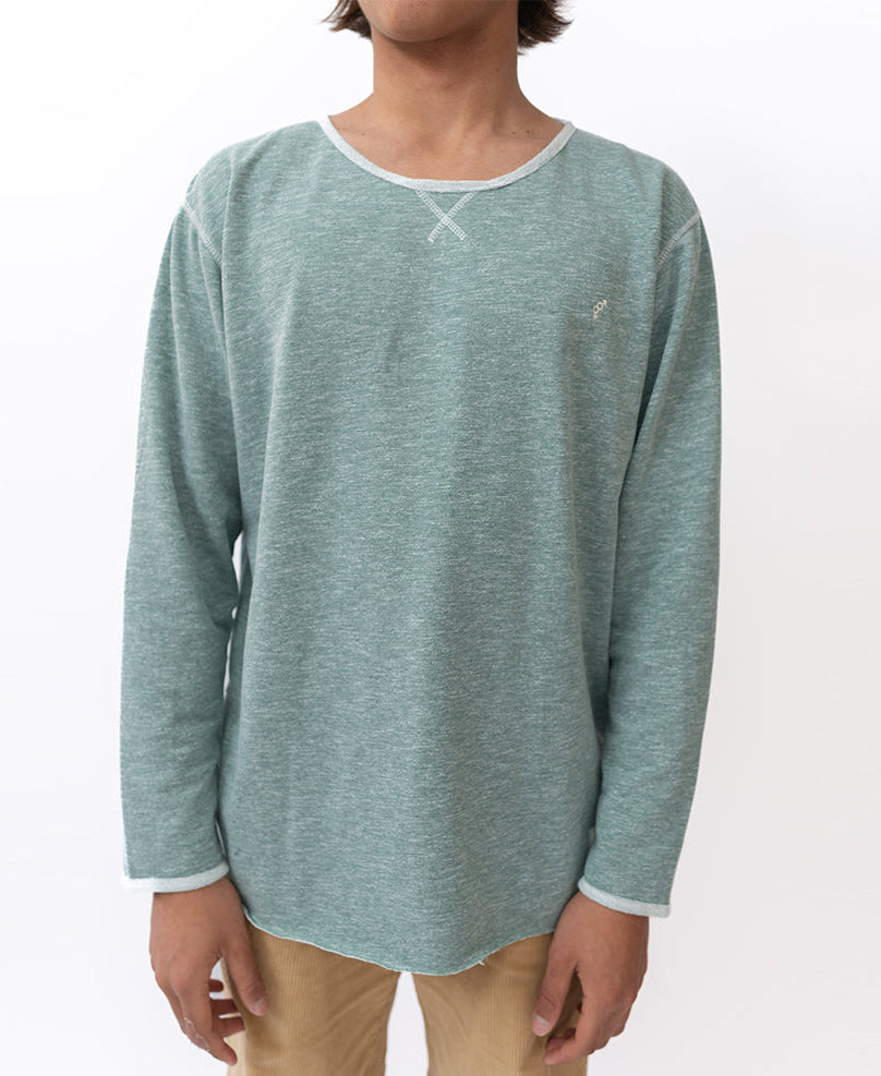 A person wearing the Golden Breed Classic Rag Top in Surf Green Marle and tan pants stands against a plain white background.