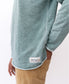 A person wears the Golden Breed Classic Rag Top in Surf Green Marle with tan corduroy pants, featuring a subtle Galita Beach label at the hem for a retro-inspired look.