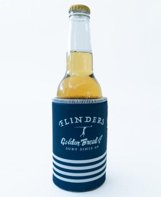 A Flinders Stubby Beach Boy | Navy by Golden Breed holds a glass beer bottle, featuring blue and white stripes, on a plain white background.