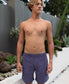 A young man stands shirtless outdoors near a modern garden, wearing Golden Breeds Floyd Cord Elastic Walkshort in Port.