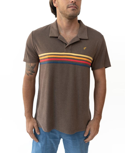 Man wearing a Golden Breed Vintage Long Island Polo in wash brown with horizontal yellow, orange, and red chest stripes, paired with blue pants, standing against a white background.