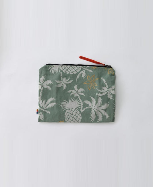 The Marco Wet Travel Bag | Sage by Golden Breed is a small, water-resistant pouch with a green background, white pineapples and leaves, a black zipper, and a red pull—ideal for carrying your essentials on the go.