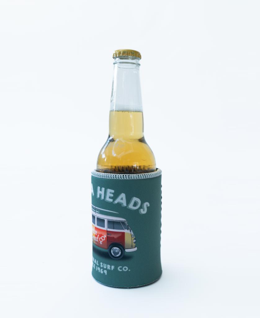 A beer bottle in a Golden Breed Noosa Stubby Kombi | Surf Green holder, featuring a red and white van illustration and “Noosa Heads” text on a white background.