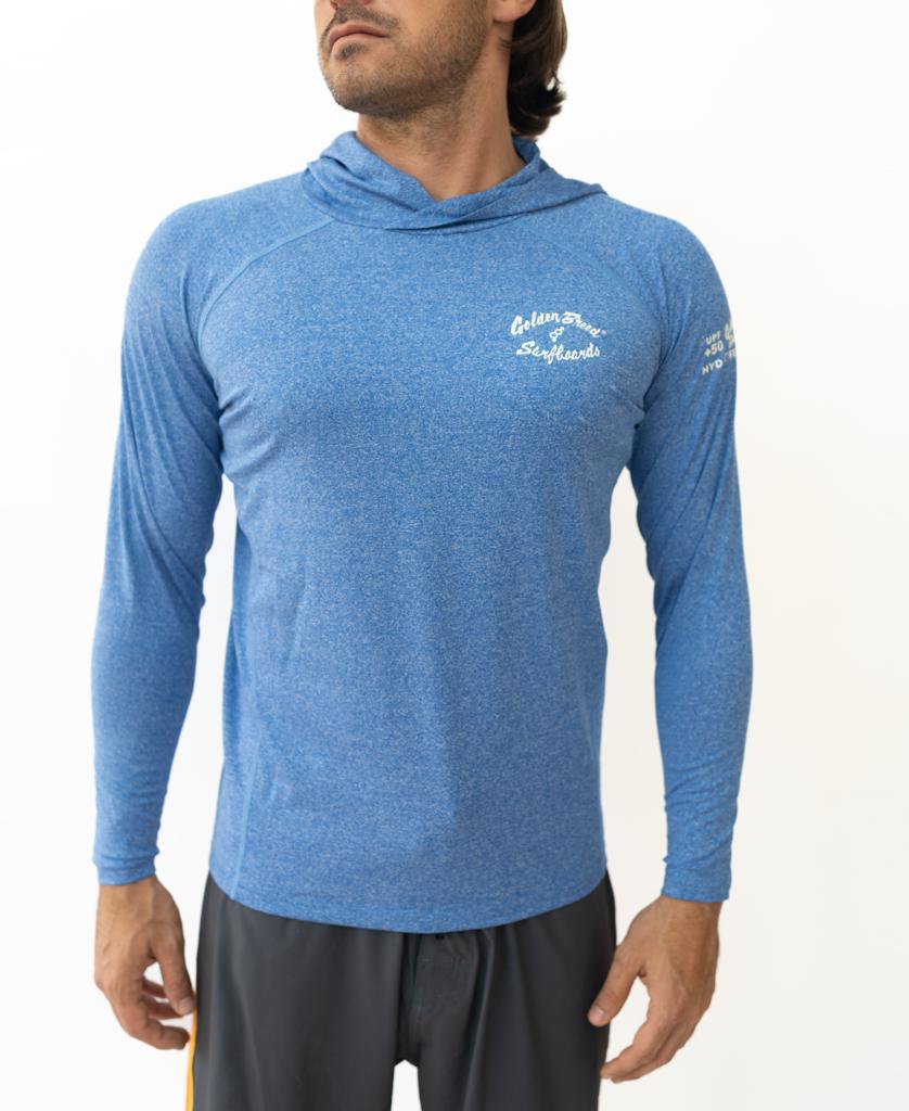 Man wearing Golden Breeds Rapper Hoodie Rash Shirt in Blue Marle, featuring white chest and sleeve text, paired with black athletic shorts for quick-drying comfort and sun protection, standing against a plain white background.