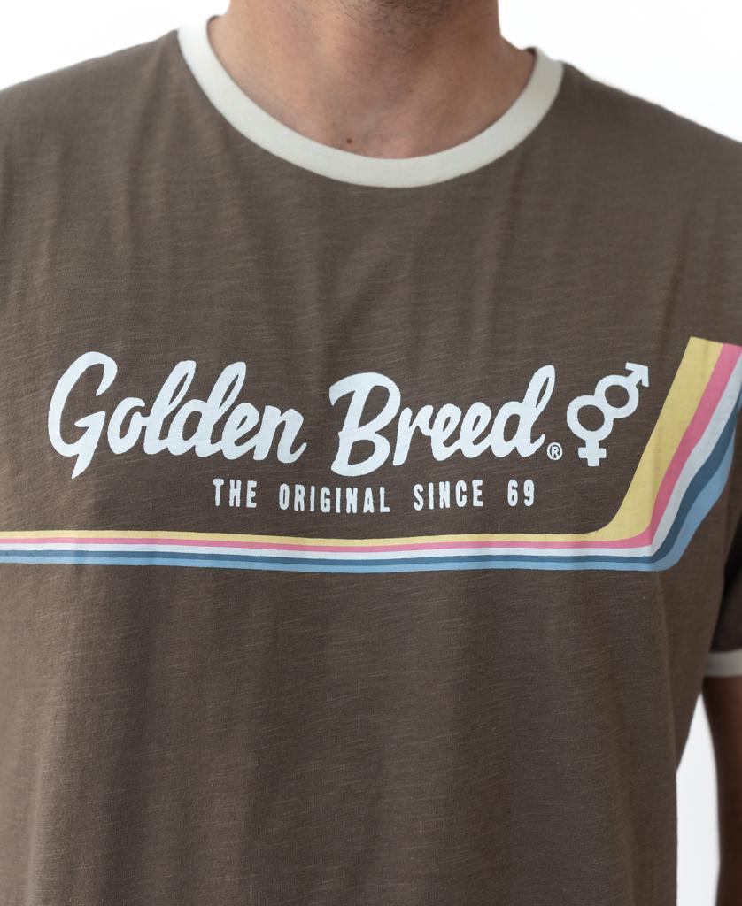 Sporting the Golden Breed Retro Ringer Tee in Wash Brown, featuring “The Original Since 69” and rainbow stripes—perfect for channeling classic 70s vibes.