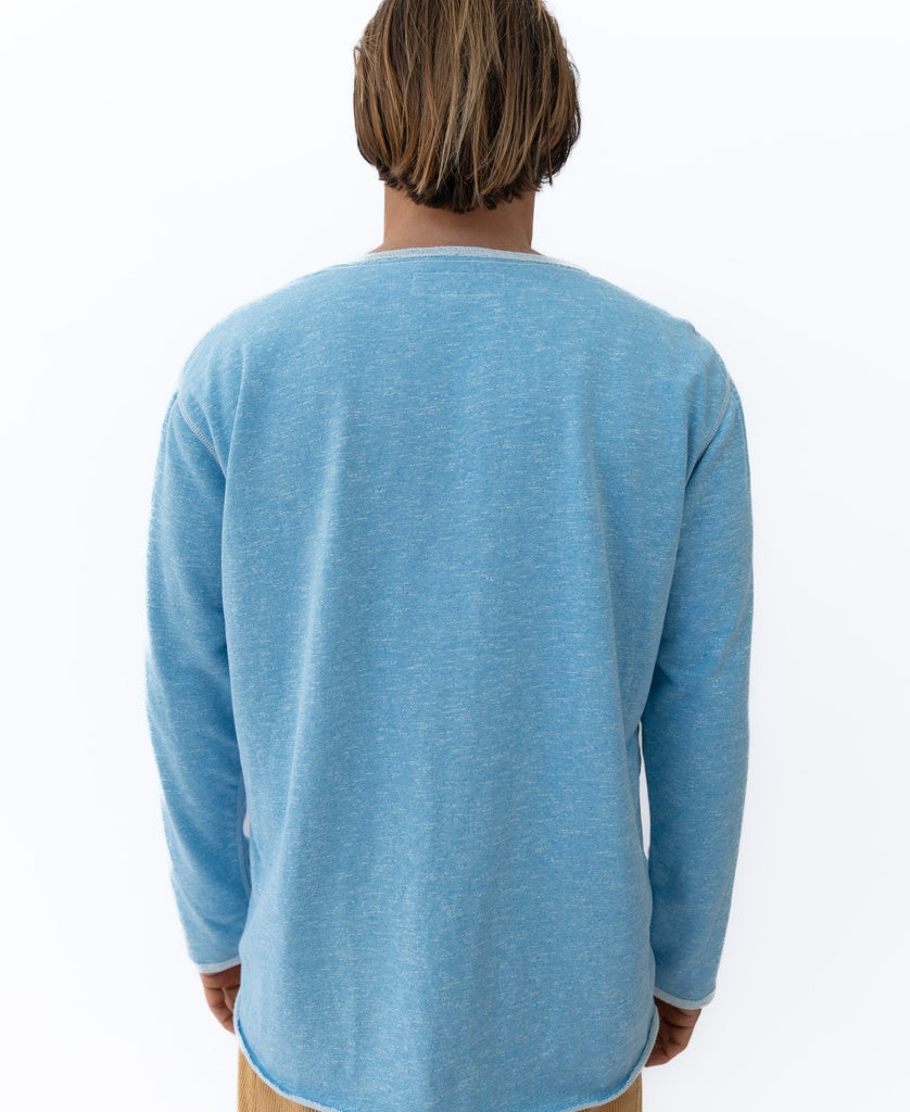 A person with light brown hair is shown from the back wearing the Golden Breed Retro Rag Top | Sky Marle and tan pants against a plain white background.