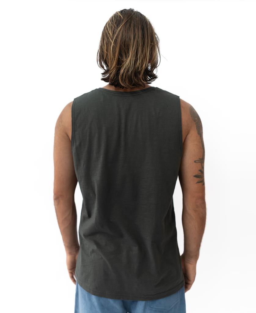 A person with shoulder-length hair is seen from behind, wearing the Golden Breed Retro Muscle Tank in Wash Black and light blue shorts against a plain white background—a timeless Golden Breed style.