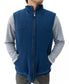A person wears a sleeveless Golden Breed Thredbo Vest | Midnight, made from polyester polar fleece, over a gray long-sleeve shirt with hands in vest pockets, standing against a white background.