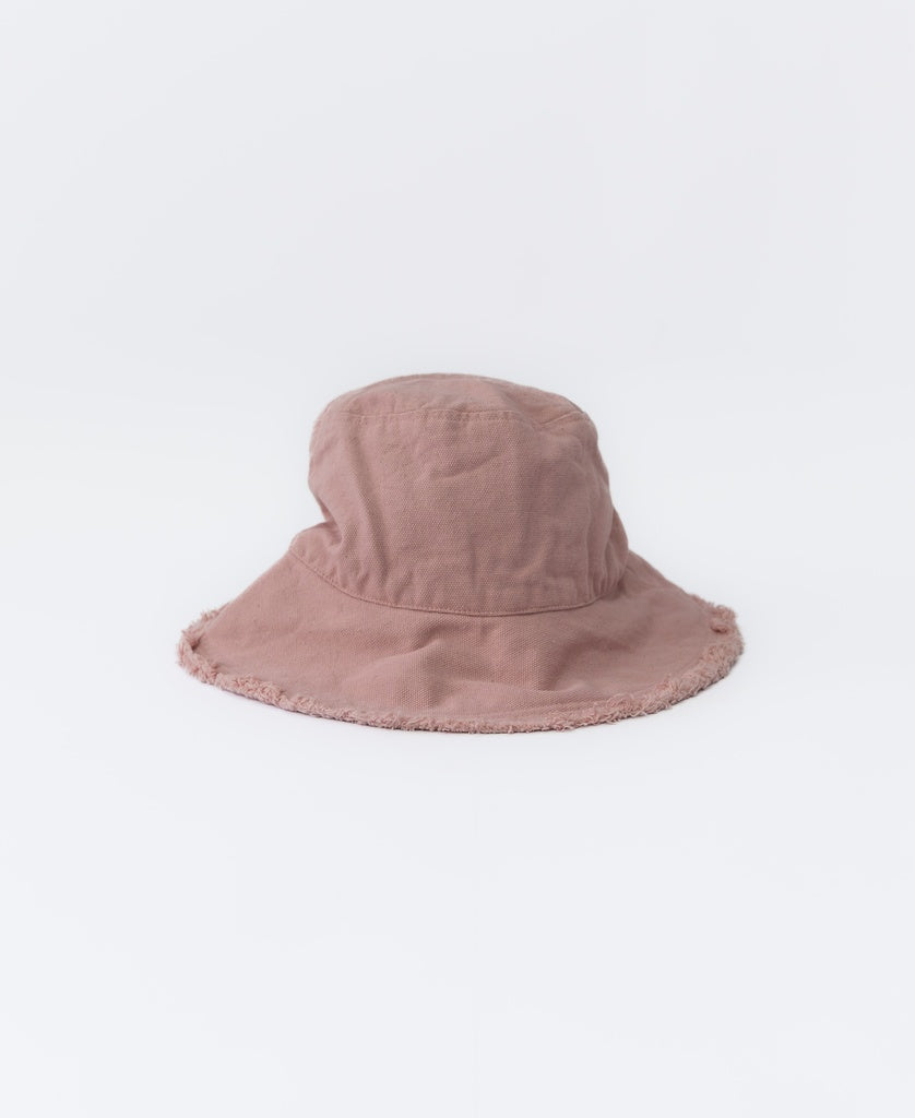 The Lazy Beach Halo Bucket Hat | Blush, handmade in Indonesia with frayed edges and a light brown hue, is shown against a plain white background.